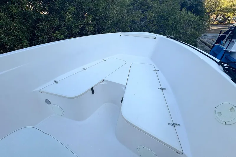 Slide: The Image of 2001 Grady-White Chase 263 boat interior with white seating and storage compartments. - 16