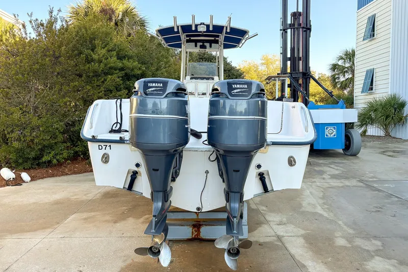 Slide: The Image of 2001 Grady-White Chase 263 boat with dual Yamaha outboard motors, docked outdoors. - 2