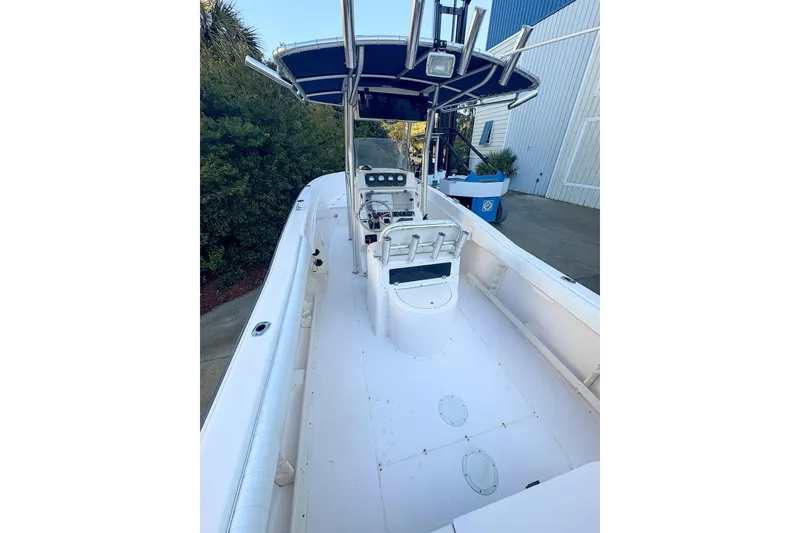 Slide: The Image of 2001 Grady-White Chase 263 boat with center console and T-top, docked outdoors. - 4