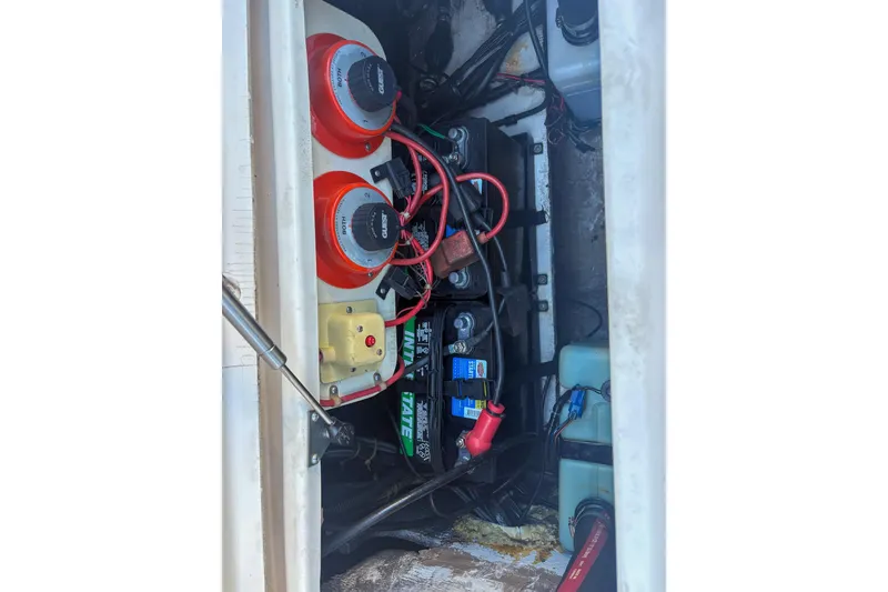 Slide: The Image of 2001 Grady-White Chase 263 boat battery compartment with wiring and switches. - 8