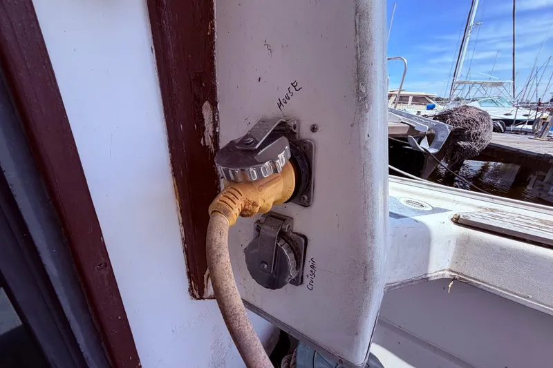 Slide: The Image of Power connection on a 1978 Mainship 34 Trawler at a marina dock. - 13