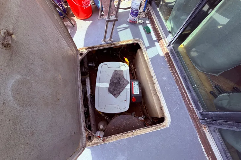 Slide: The Image of Engine compartment of a 1978 Mainship 34 Trawler with open hatch. - 14