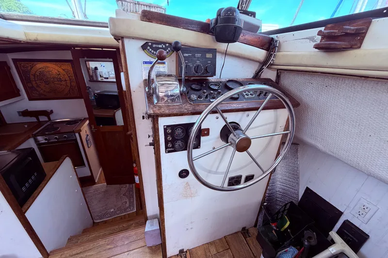 Slide: The Image of Interior helm of a 1978 Mainship 34 Trawler with steering wheel and navigation controls. - 18