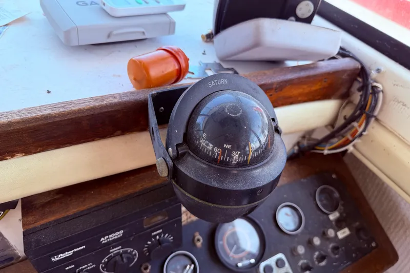 Slide: The Image of Compass and navigation equipment on 1978 Mainship 34 Trawler's control panel. - 19