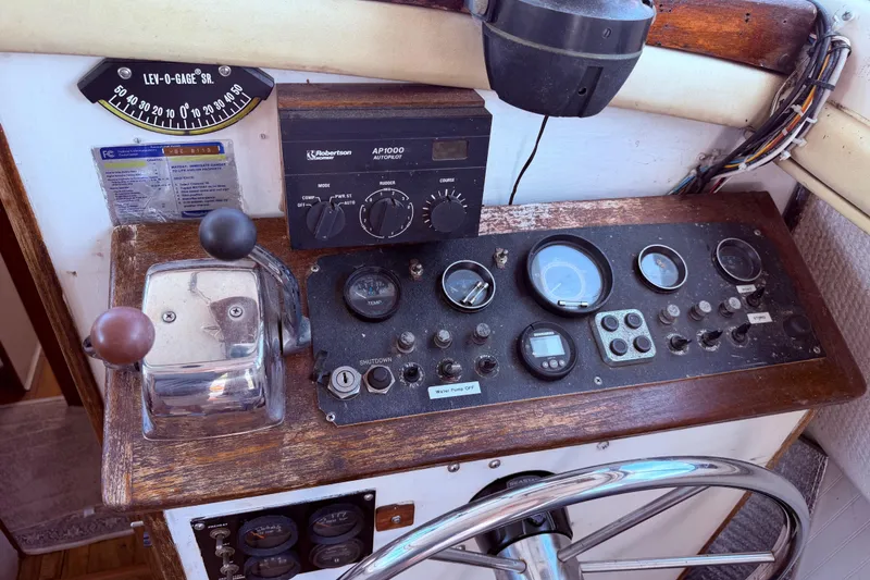 Slide: The Image of 1978 Mainship 34 Trawler helm with gauges, controls, and autopilot system. - 21