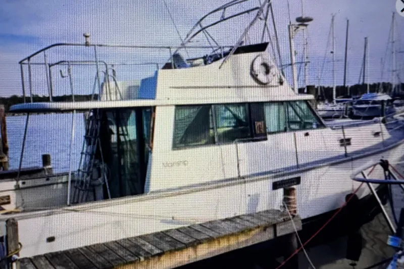 Slide: The Image of 1978 Mainship 34 Trawler docked at marina, side view. - 3