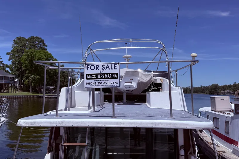 Slide: The Image of 1978 Mainship 34 Trawler for sale at McCotters Marina, docked by a scenic waterfront. - 5