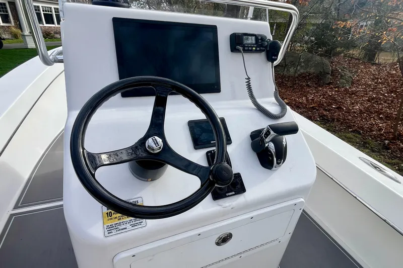 Slide: The Image of 2023 Jones Brothers 23 Cape Fisherman Lite Tackle boat console with steering wheel and controls. - 11