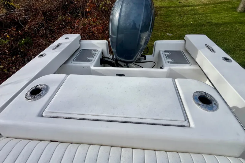 Slide: The Image of 2023 Jones Brothers 23 Cape Fisherman Lite Tackle boat, rear view with engine and seating. - 13