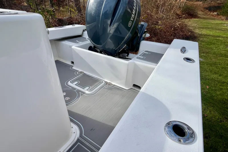 Slide: The Image of 2023 Jones Brothers 23 Cape Fisherman Lite Tackle boat with Yamaha engine, docked on grass. - 14