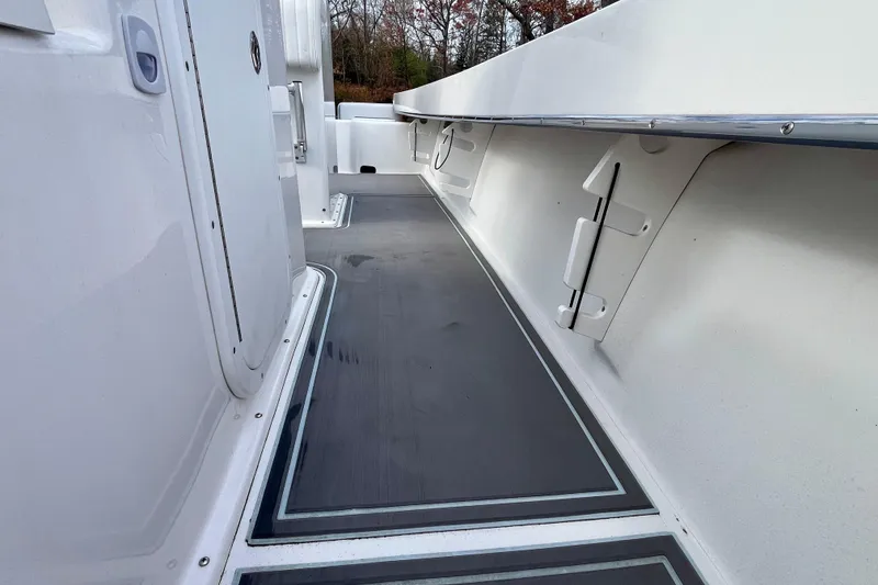 Slide: The Image of 2023 Jones Brothers 23 Cape Fisherman Lite Tackle boat interior, featuring sleek deck design. - 16