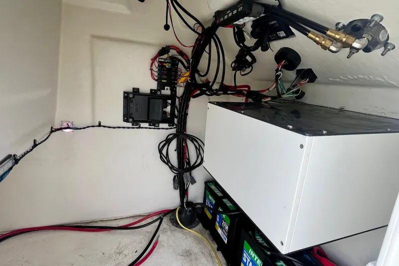 Slide: The Image of Electrical wiring and components inside a 2023 Jones Brothers 23 Cape Fisherman Lite Tackle boat. - 23