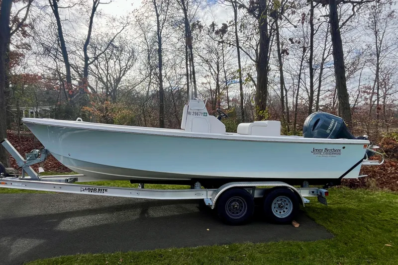 Slide: The Image of 2023 Jones Brothers 23 Cape Fisherman Lite Tackle boat on trailer, parked outdoors. - 26