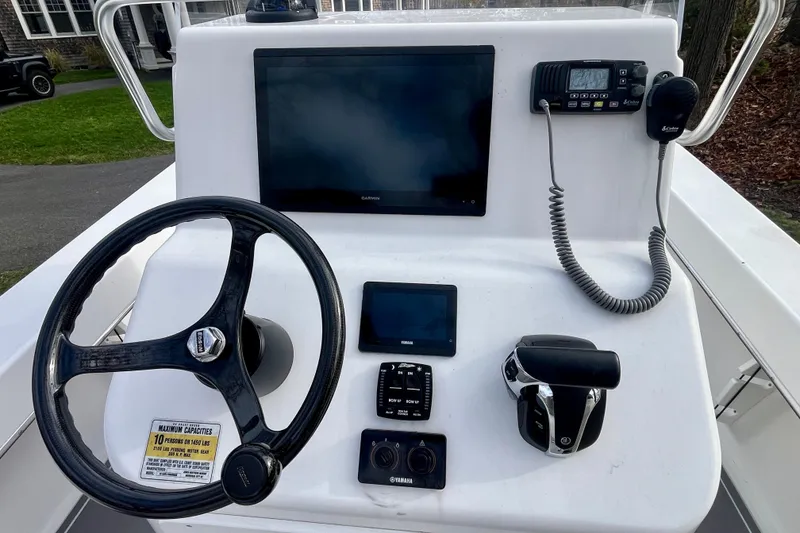 Slide: The Image of 2023 Jones Brothers 23 Cape Fisherman Lite Tackle boat console with steering wheel and controls. - 4