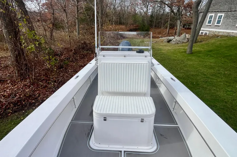 Slide: The Image of 2023 Jones Brothers 23 Cape Fisherman Lite Tackle boat, white interior, outdoor setting. - 8
