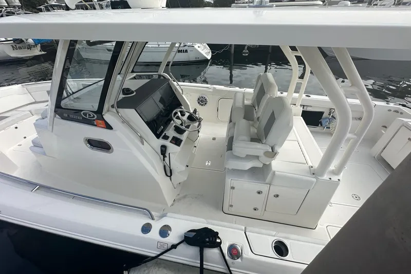Slide: The Image of 2023 Pursuit S 328 Sport boat interior with helm and seating area. - 2