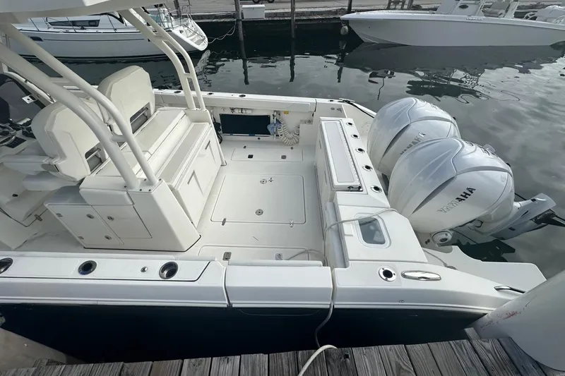 Slide: The Image of 2023 Pursuit S 328 Sport boat with dual Yamaha engines docked at marina. - 3