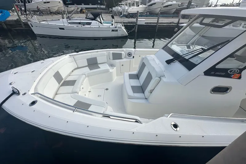 Slide: The Image of 2023 Pursuit S 328 Sport boat with spacious seating at a marina. - 4