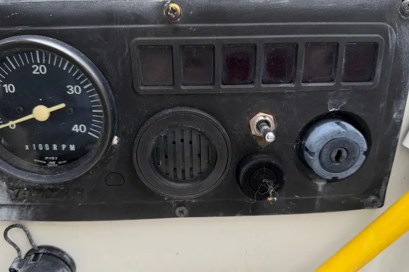 Slide: The Image of Control panel of a 1987 O'Day 322 sailboat with RPM gauge and switches. - 10
