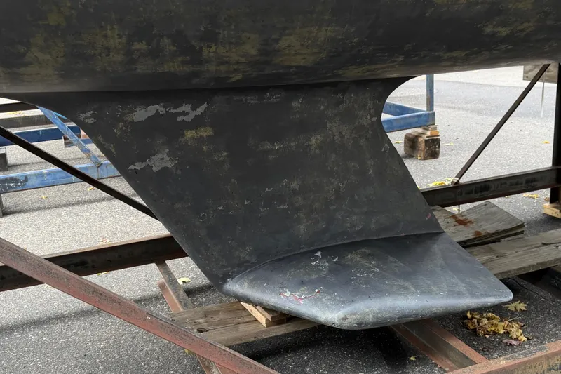 Slide: The Image of Keel of 1987 O'Day 322 sailboat on a trailer, showing wear and weathering. - 11