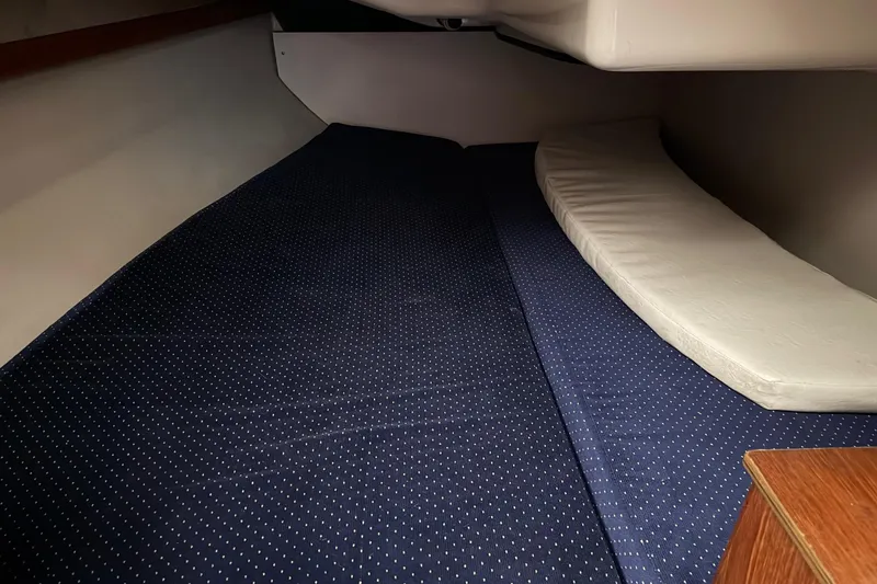 Slide: The Image of Interior cabin of 1987 O'Day 322 sailboat with blue and white bedding. - 25