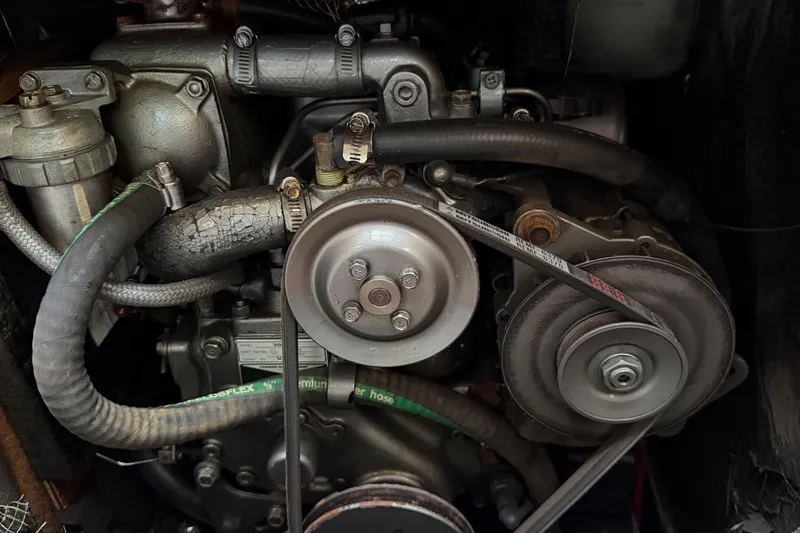 Slide: The Image of 1987 O'Day 322 engine close-up with belts and hoses visible. - 26