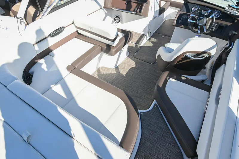 Slide: The Image of 2023 Cobalt CS22 boat interior with luxurious seating and modern dashboard design. - 11