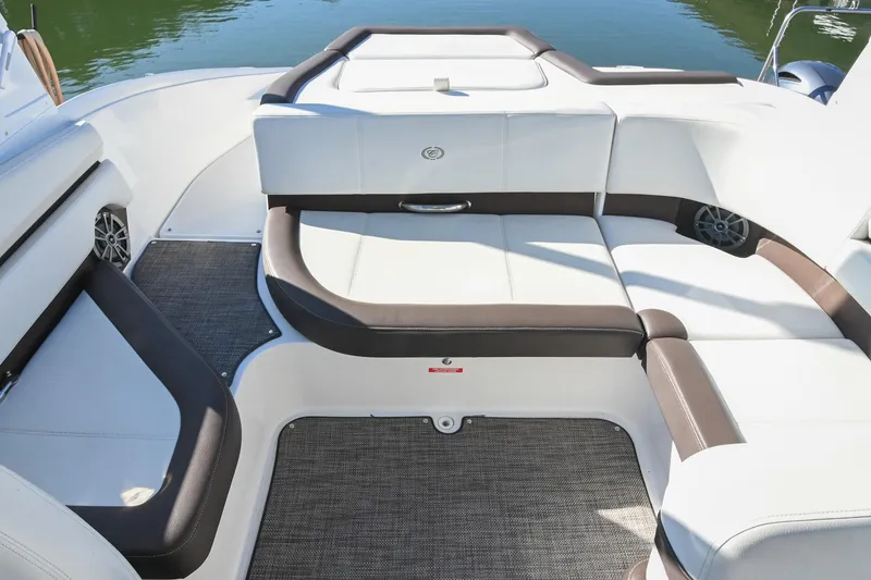Slide: The Image of 2023 Cobalt CS22 boat interior with white and brown seating, carpeted flooring, and water view. - 12