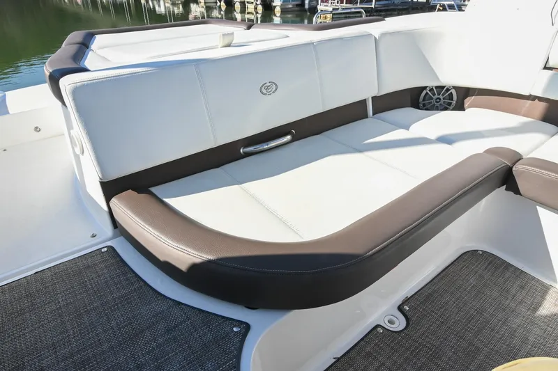 Slide: The Image of 2023 Cobalt CS22 boat interior with white and brown seating, featuring a sleek design. - 14