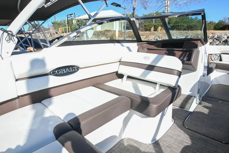 Slide: The Image of 2023 Cobalt CS22 boat interior with white and brown seating, showcasing luxury design. - 17