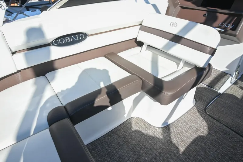 Slide: The Image of 2023 Cobalt CS22 boat interior with brown and white seating, showcasing luxury design. - 18