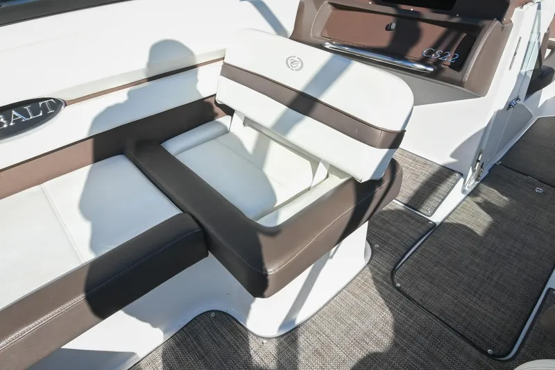 Slide: The Image of 2023 Cobalt CS22 boat interior with cushioned seating and brown accents. - 19