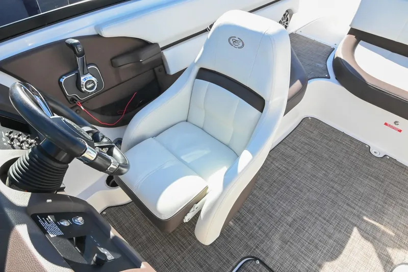 Slide: The Image of 2023 Cobalt CS22 boat interior with steering wheel and plush captain's chair. - 29