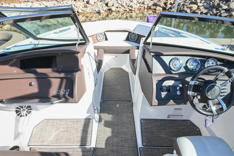 Slide: The Image of 2023 Cobalt CS22 boat interior with dashboard, steering wheel, and seating area. - 30