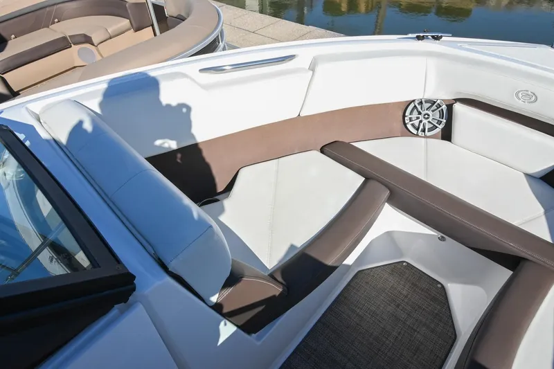 Slide: The Image of 2023 Cobalt CS22 boat interior with brown and white seating, speaker, and shadow. - 32