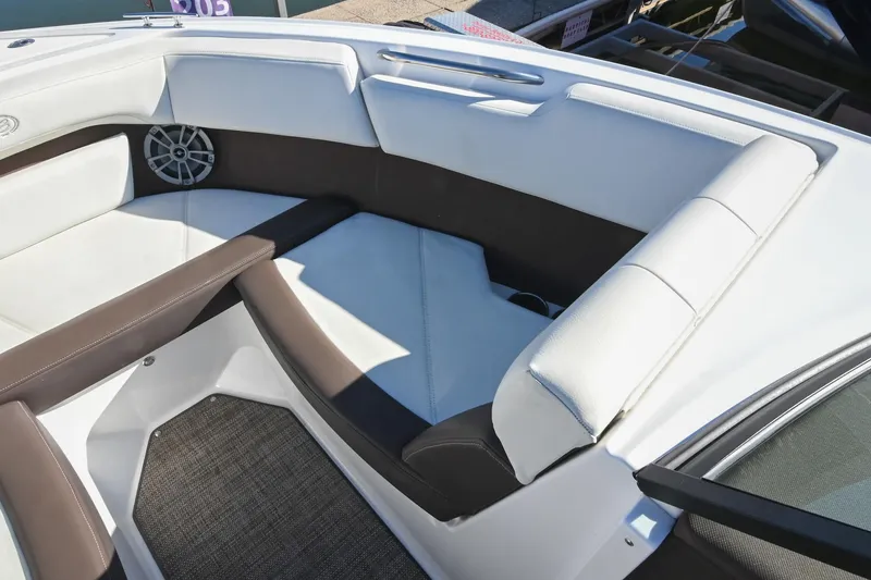 Slide: The Image of 2023 Cobalt CS22 boat interior with white and brown seating, speaker, and carpeted floor. - 33