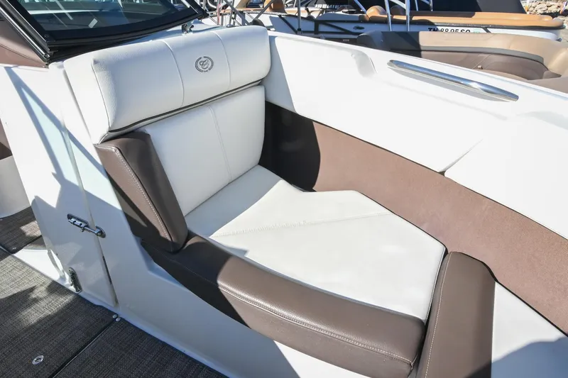 Slide: The Image of 2023 Cobalt CS22 boat interior with white and brown cushioned seating. - 35