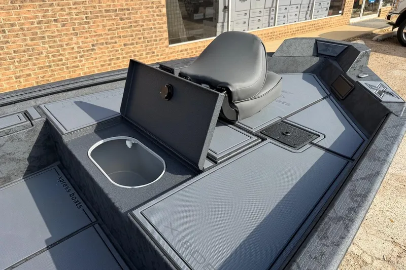 Slide: The Image of 2026 Xpress X18DB boat interior with seating and storage compartments. - 2