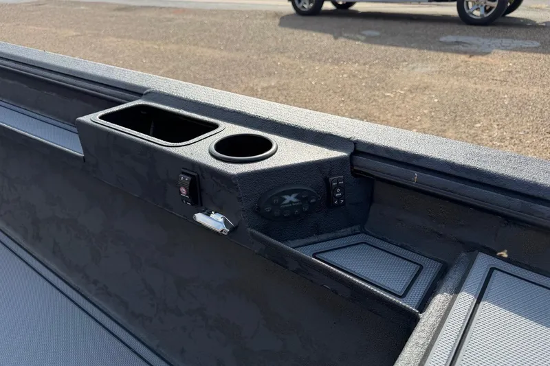 Slide: The Image of 2026 Xpress X18DB boat interior with cup holders and control panel. - 5