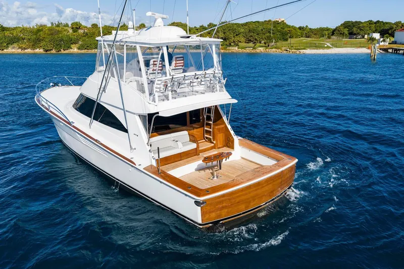 Slide: The Image of 2025 Viking 58 Convertible yacht cruising on blue ocean waters. - 12