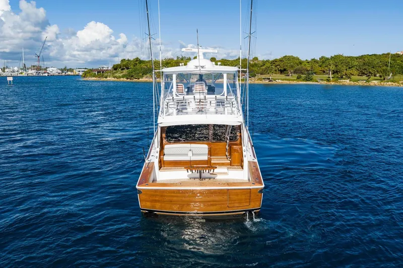 Slide: The Image of 2025 Viking 58 Convertible yacht on blue water, showcasing sleek design and luxury features. - 13