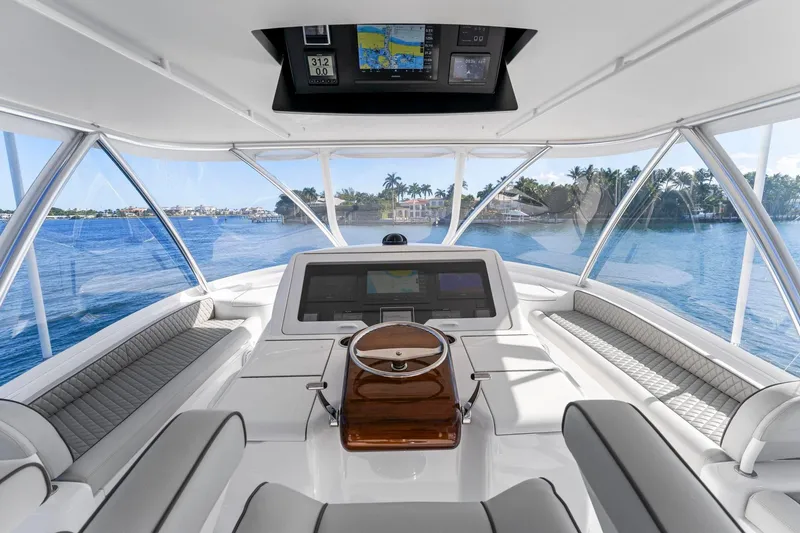 Slide: The Image of Interior view of 2025 Viking 58 Convertible yacht, featuring modern helm and panoramic windows. - 17