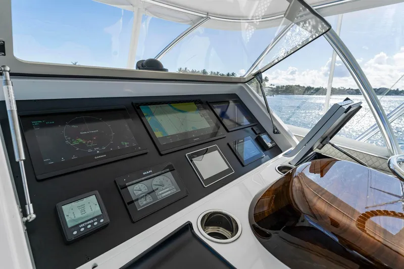Slide: The Image of 2025 Viking 58 Convertible yacht dashboard with advanced navigation displays and controls. - 19