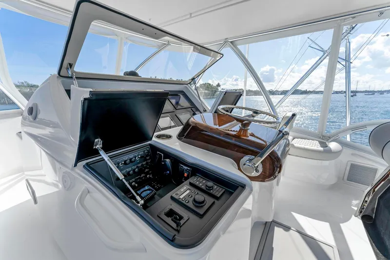 Slide: The Image of Helm station of 2025 Viking 58 Convertible yacht with modern controls and ocean view. - 20