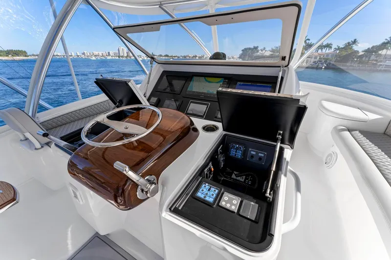 Slide: The Image of 2025 Viking 58 Convertible yacht helm with advanced navigation controls and ocean view. - 23