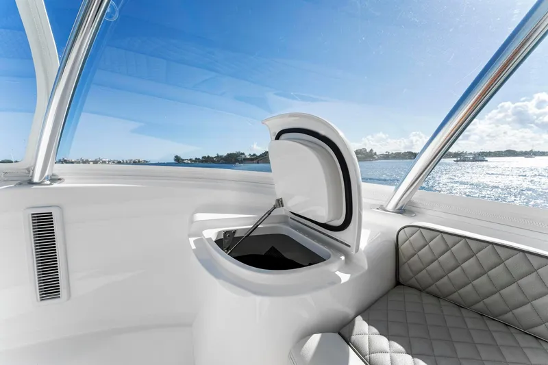 Slide: The Image of 2025 Viking 58 Convertible yacht interior with open hatch and quilted seating, ocean view. - 25