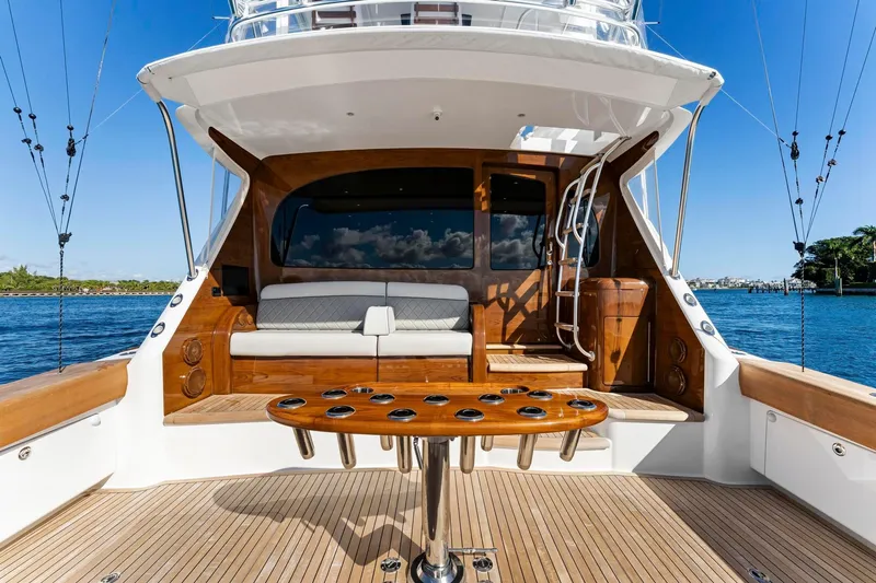 Slide: The Image of 2025 Viking 58 Convertible yacht deck with seating and fishing rod holders. - 37