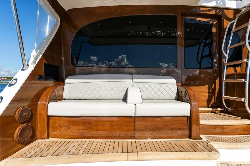 Slide: The Image of Luxury seating on 2025 Viking 58 Convertible yacht deck with wooden finish. - 39