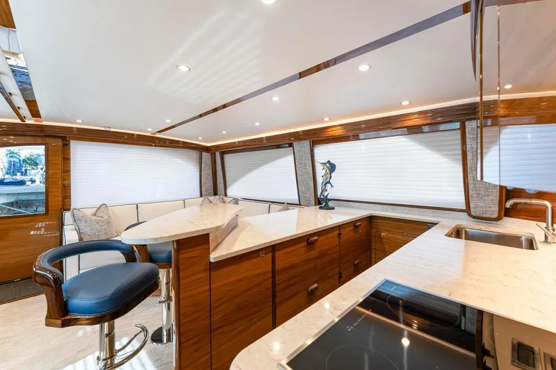 Slide: The Image of Luxurious interior of 2025 Viking 58 Convertible yacht with modern kitchen and seating area. - 47