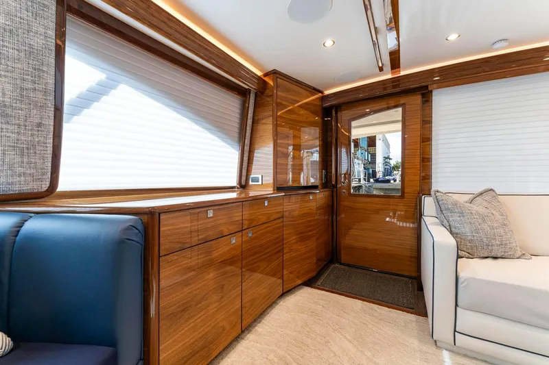 Slide: The Image of Luxurious interior of 2025 Viking 58 Convertible yacht with elegant wood finishes. - 49